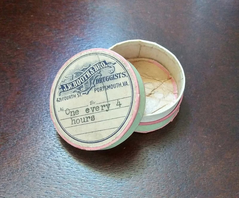 Vintage round box from L.W. Boothe & Bro. druggists in Portmouth, VA, with label 'One every 4 hours'.