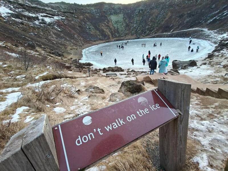 Don't walk on the ice sign at a frozen volcanic crater lake.