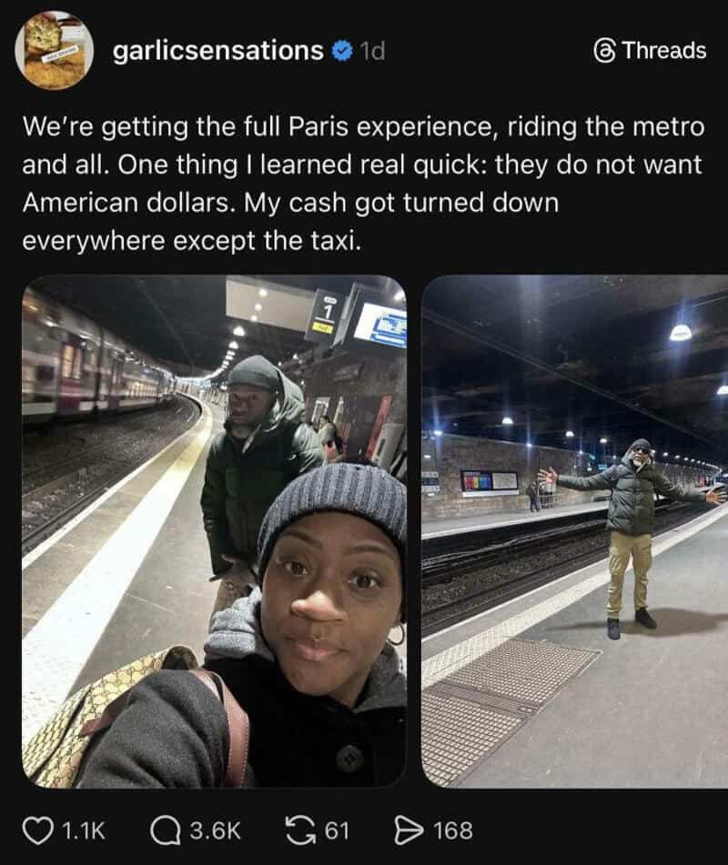 Two people at a Paris metro station, one taking a selfie, the other standing with arms outstretched.