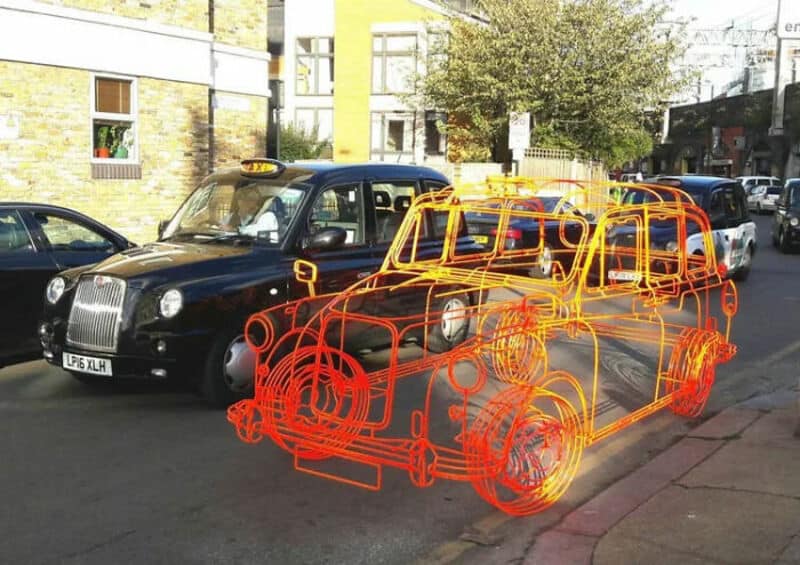 Overlay of a wireframe sketch of a classic London taxi on a real black taxi cab.