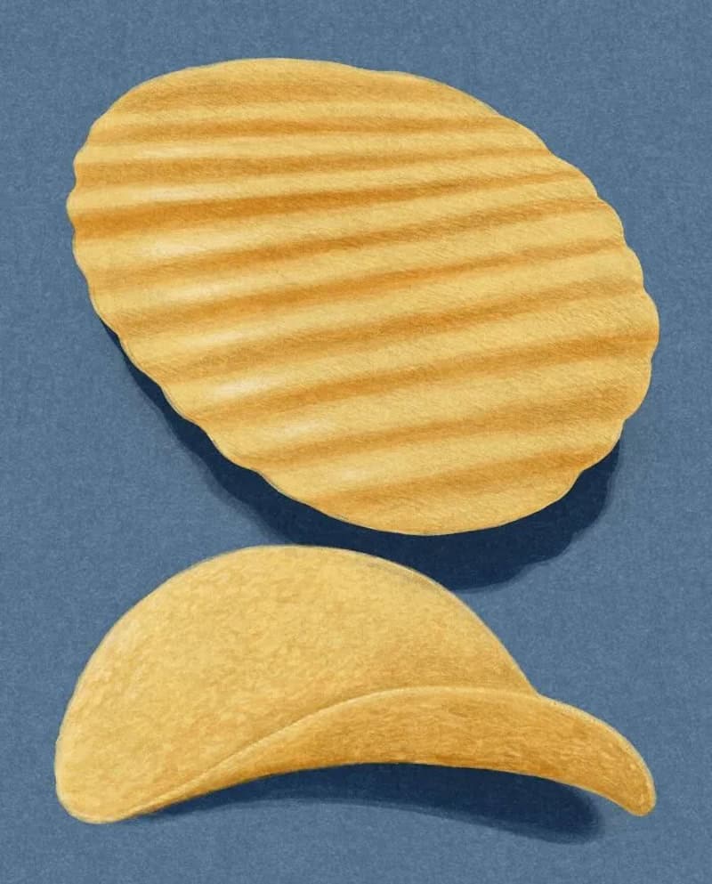 Two potato chips on a blue background, one with ridges and one curved.