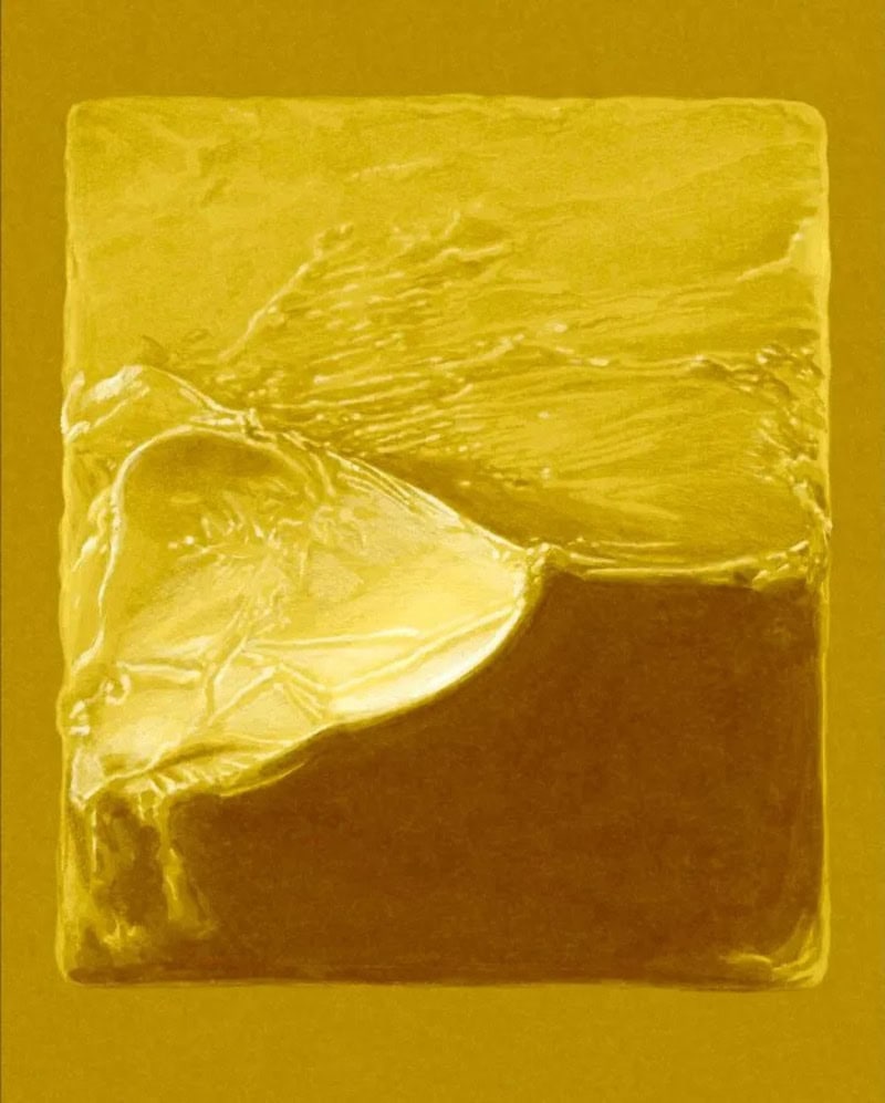 Close-up of a yellowish, textured soap bar with a layered appearance.