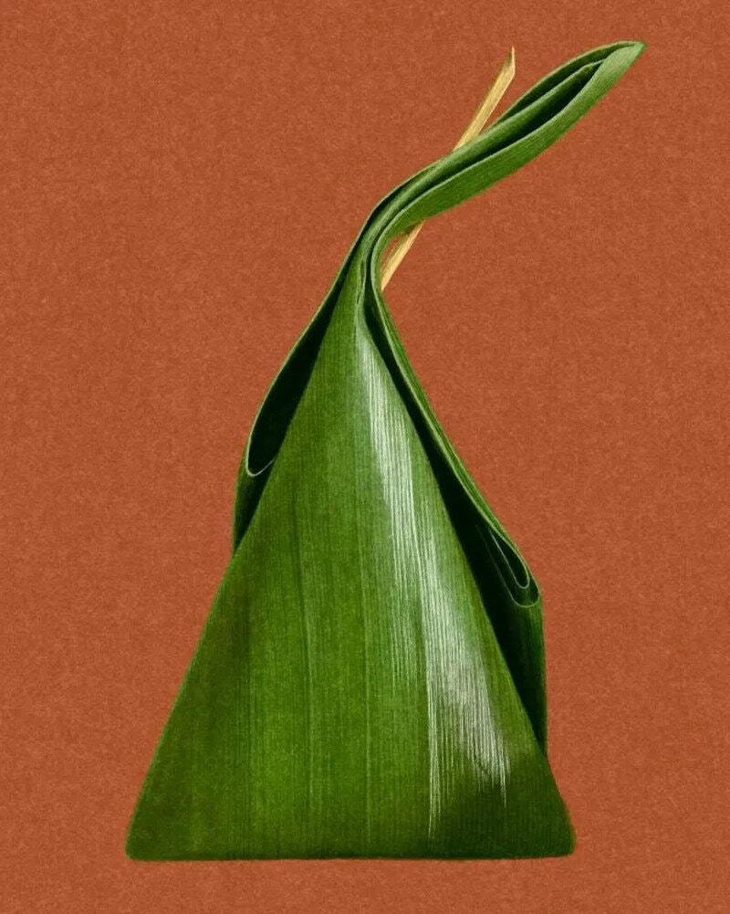 Traditional Thai dessert wrapped in banana leaf with a twisted top.