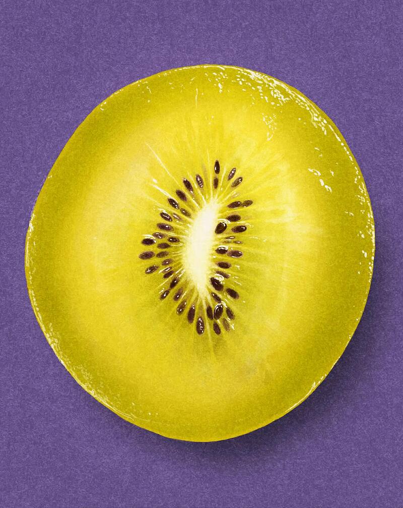 Close-up of a sliced kiwi fruit on a purple background.