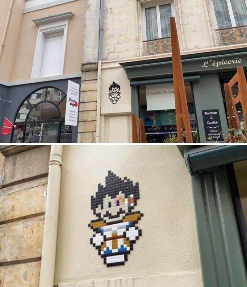 Street art mosaic of a pixelated character on a building wall.