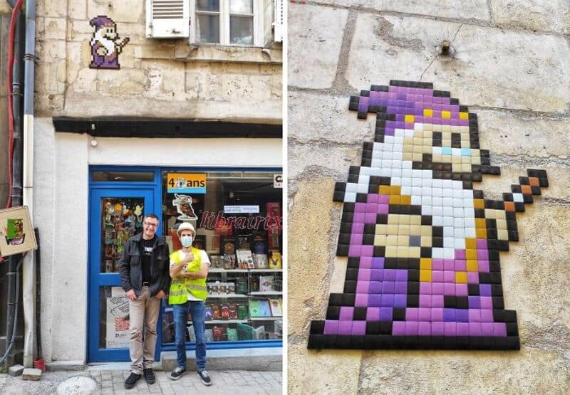 Street art mosaic of a wizard with a purple hat and robe on a wall.