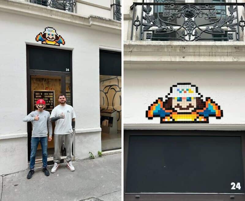 Pixel art of a character with a white hat and colorful outfit on a building wall.