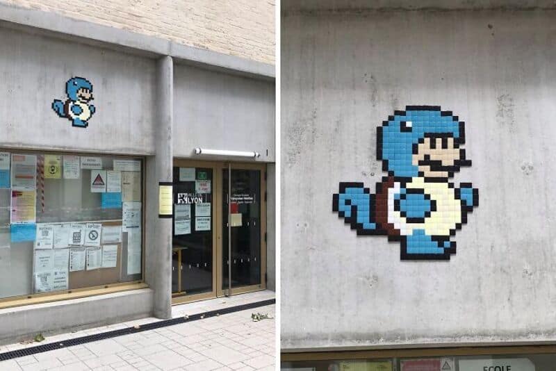 Pixel art of a blue character from Super Mario on a concrete wall.