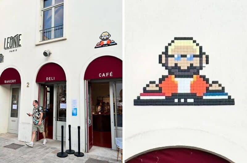 Street art mosaic of a DJ on a white building wall in Paris.