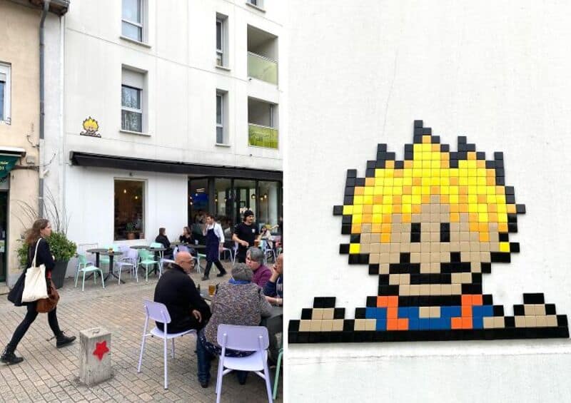 Street art mosaic of a pixelated character outside a cafe in Woup.