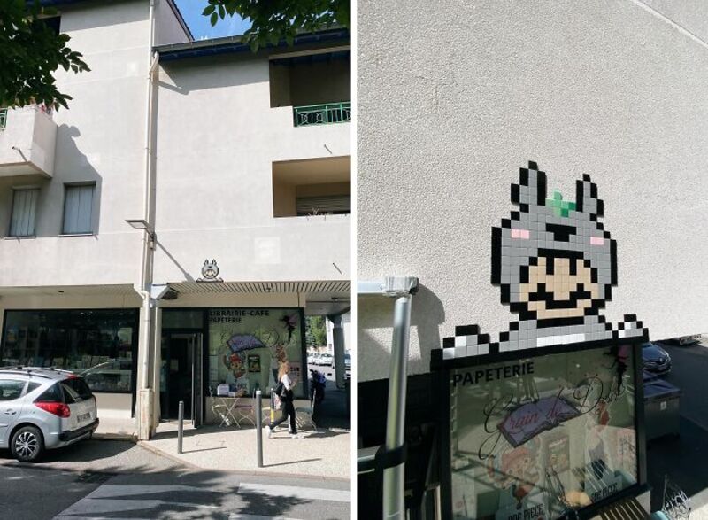 Street art mosaic of a character with a bunny hat on a building wall.