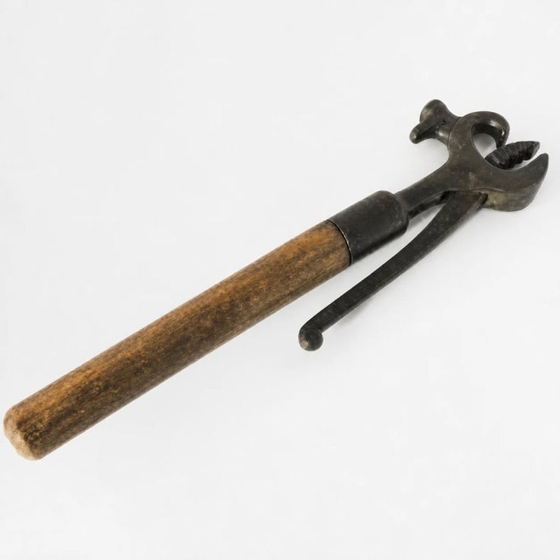 Vintage hammer with wooden handle and metal head, part of household items collection.