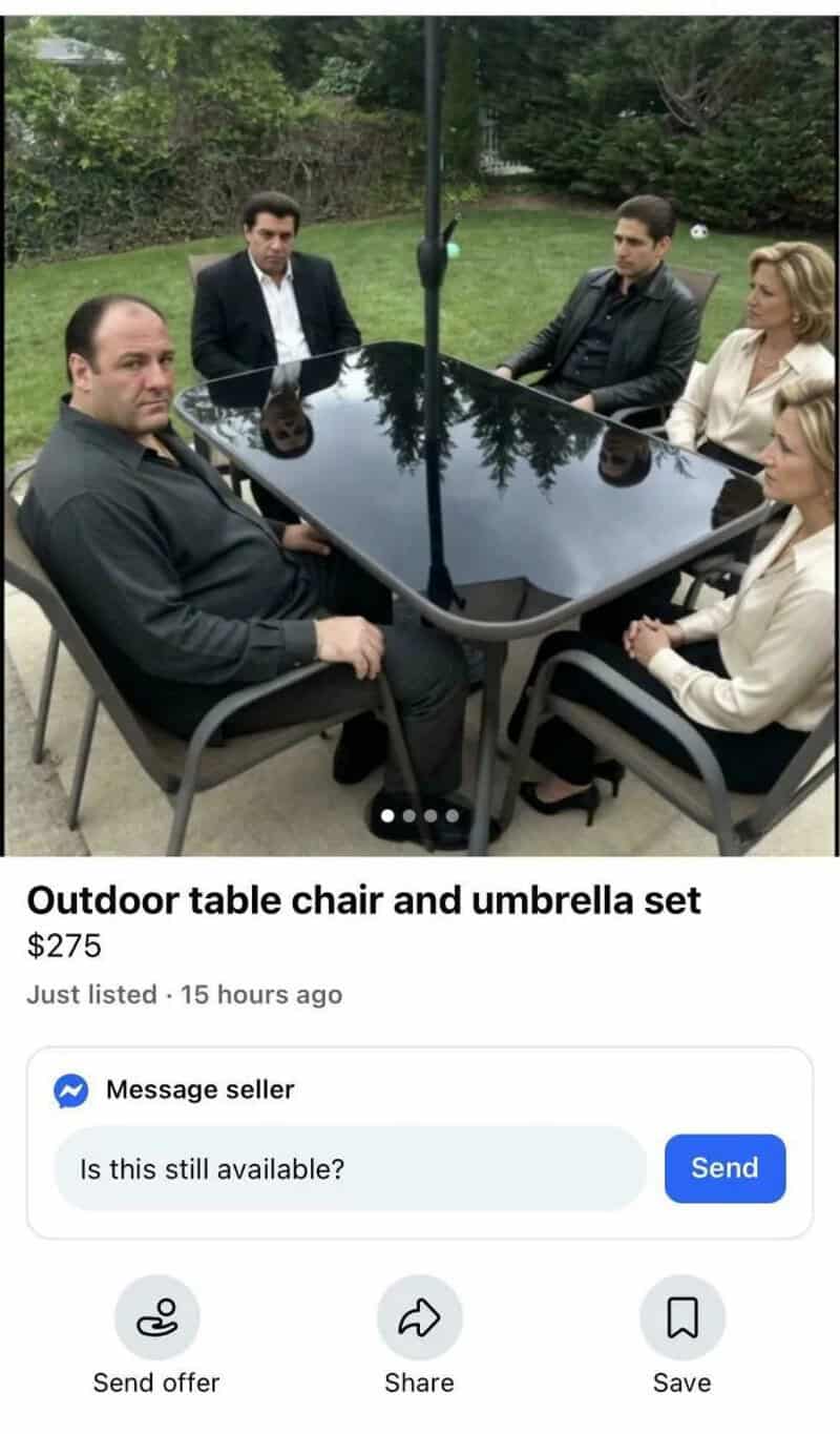 Outdoor table, chair, and umbrella set with five people sitting around it.