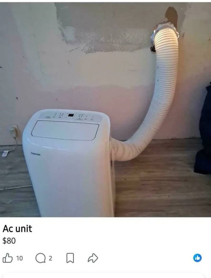 Portable AC unit with a flexible exhaust hose attached to the wall.