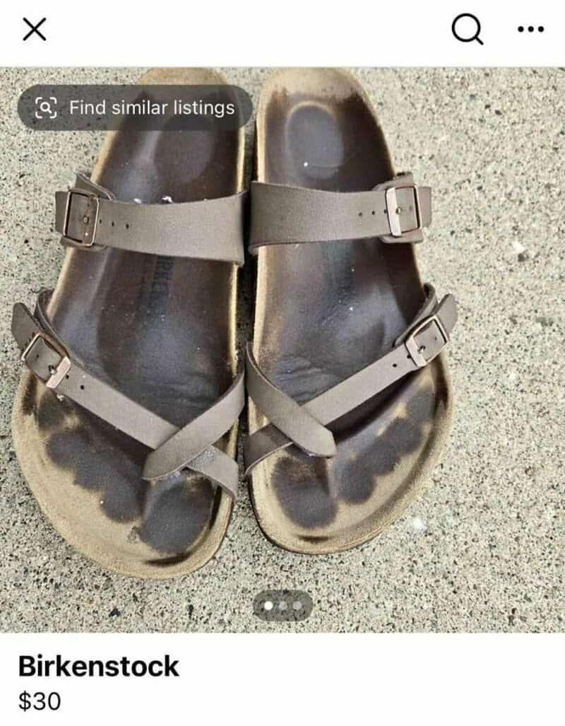 Pair of used Birkenstock sandals on sand, $30.