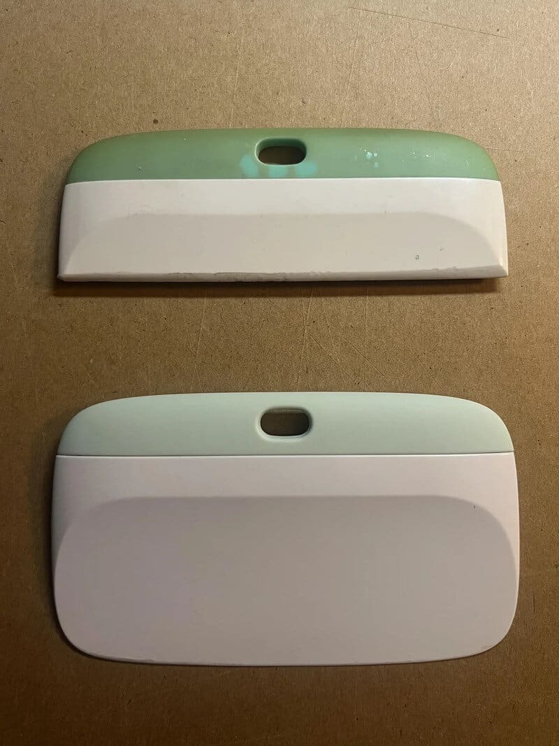 Two plastic objects with a hole at the top, one green and white, the other light green and white.