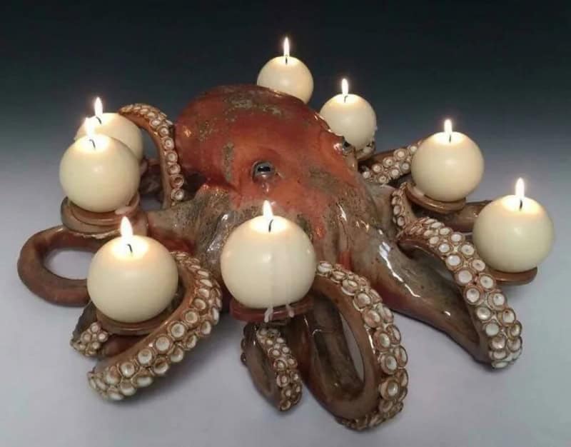 Octopus sculpture with candles on its tentacles, titled 'crafts'.