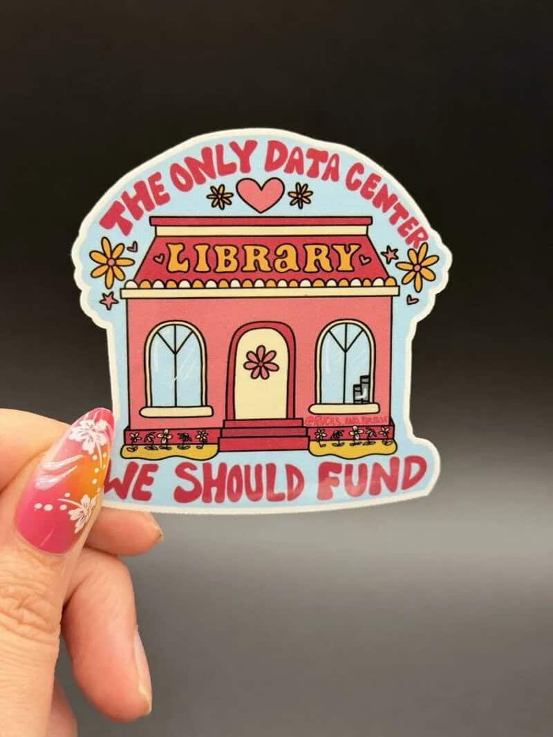 Colorful sticker of a library with the text 'The only data center we should fund'.