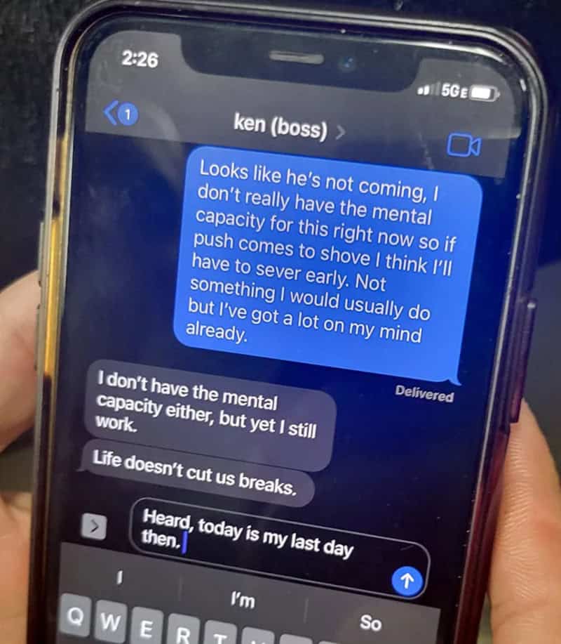 Text message conversation about a boss not coming and work stress.
