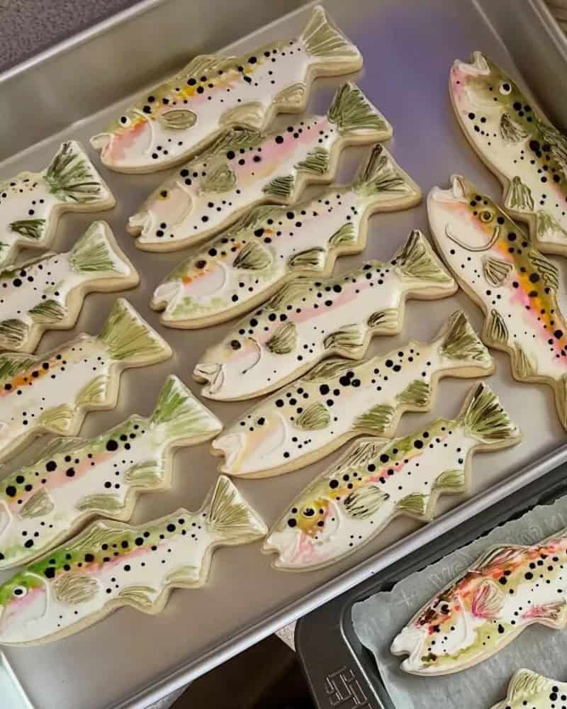 Fish-shaped cookies decorated with colorful icing and sprinkles.