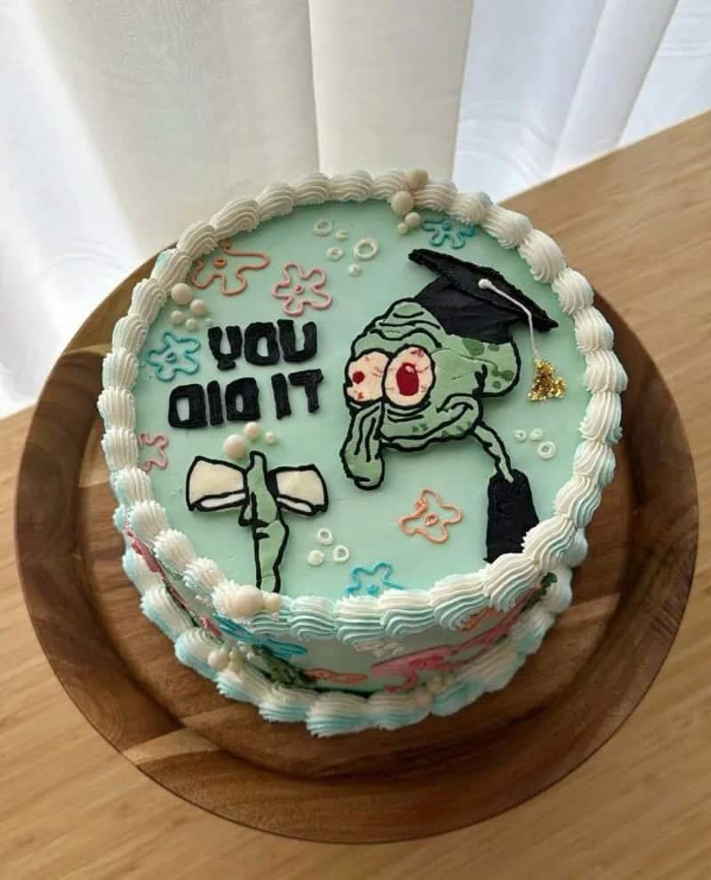 SpongeBob cake with graduation cap, bowtie, and 'You Did It' message.