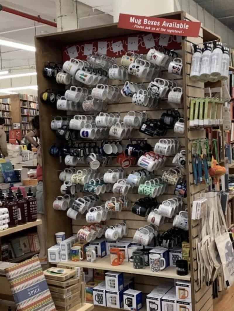 Display of mug boxes on a store shelf with a sign reading 'Mug Boxes Available'.