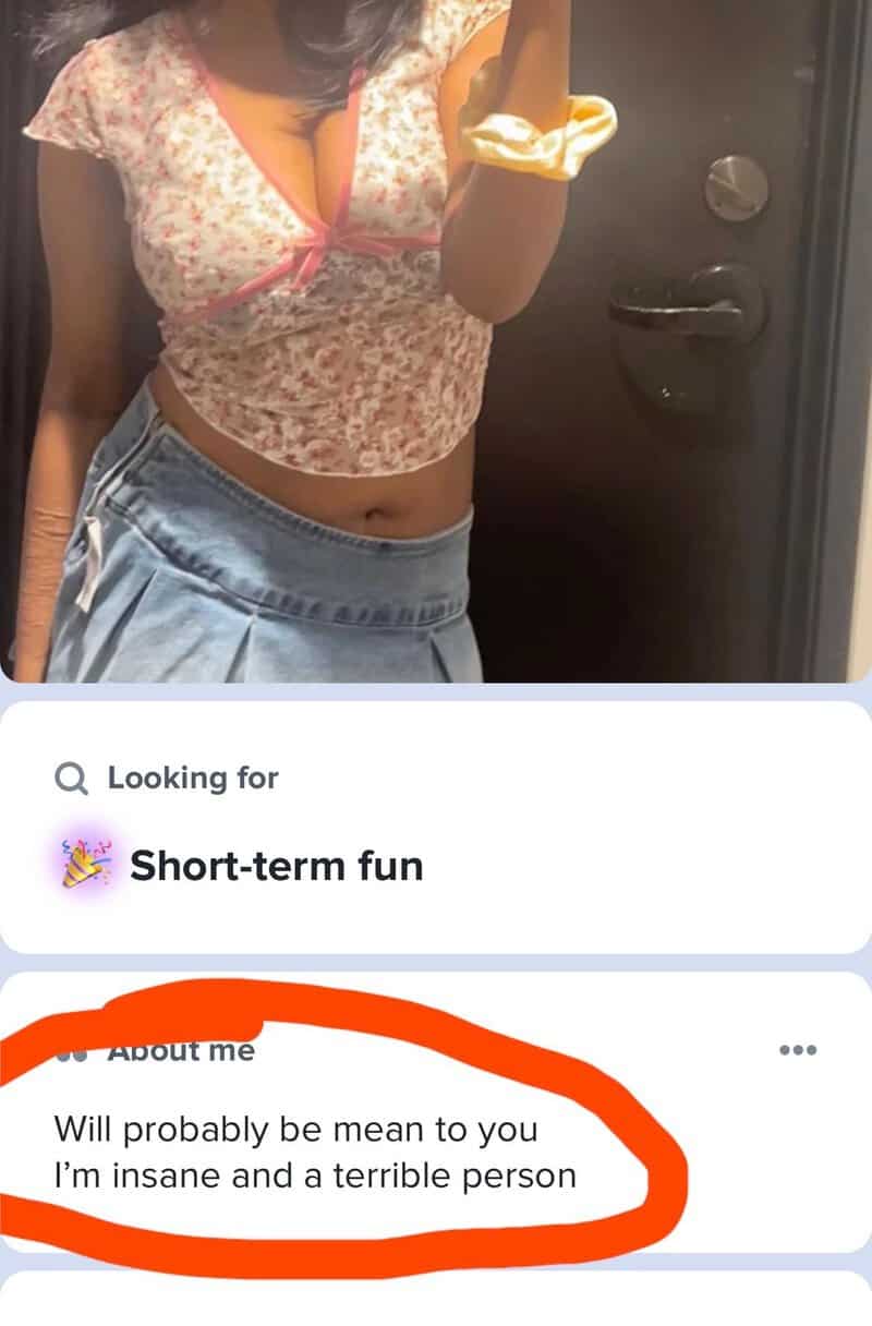 Person taking mirror selfie with floral top and denim shorts, profile says 'Will probably be mean to.