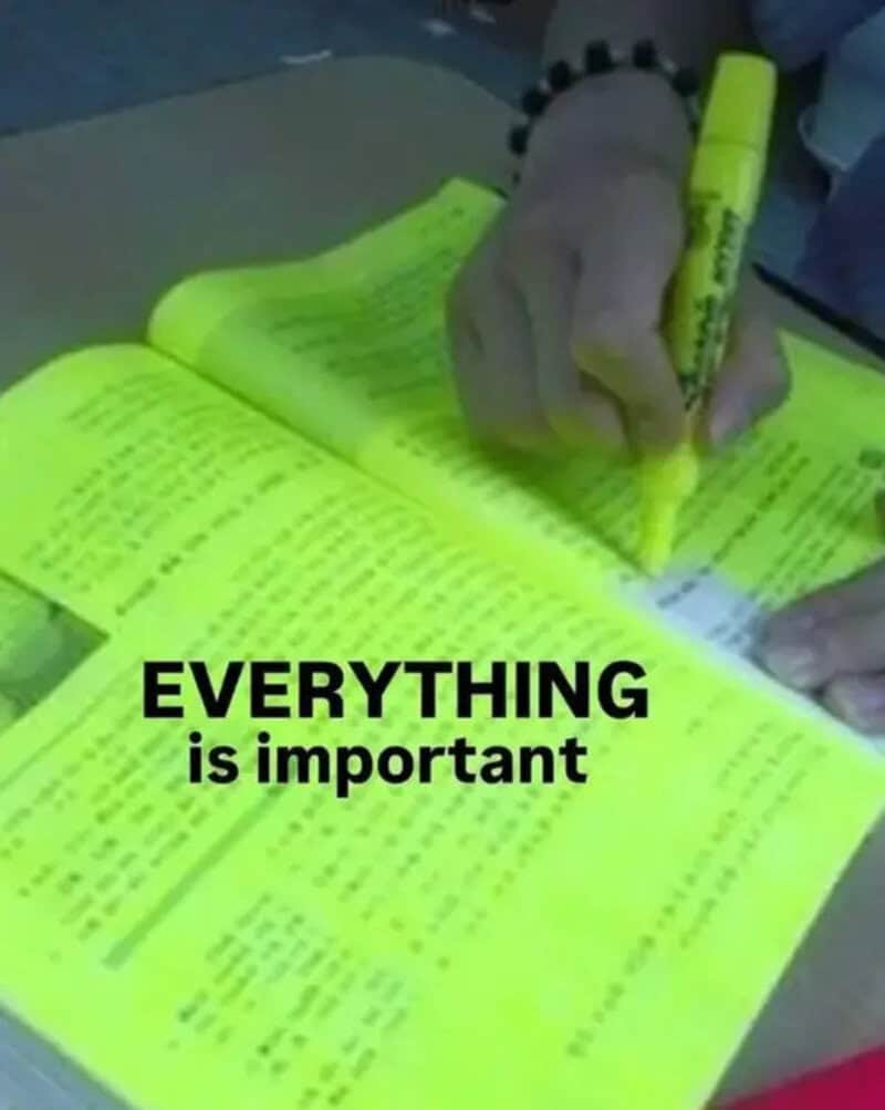 Person highlighting text in a bright yellow book with a yellow marker.