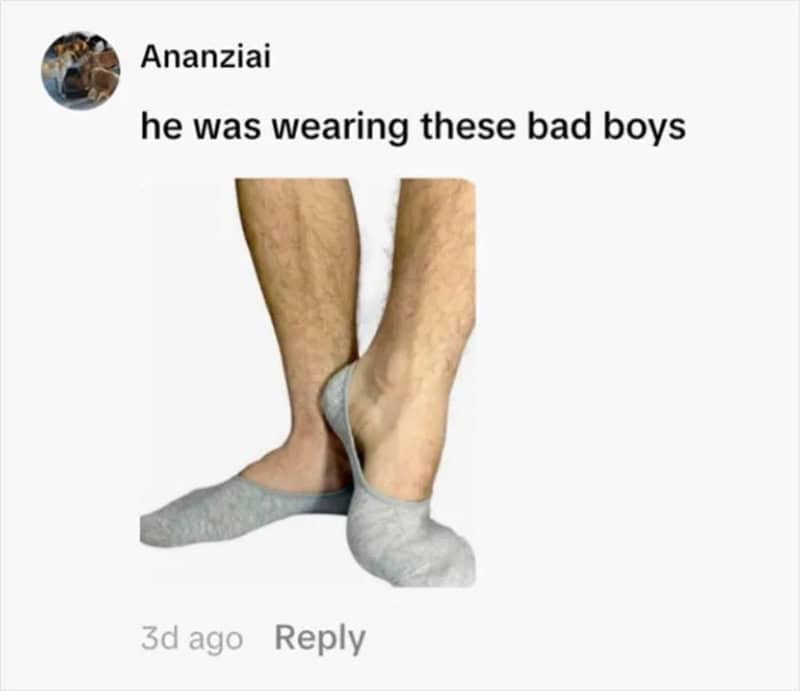 Image of two legs with mismatched socks, one gray and one beige.
