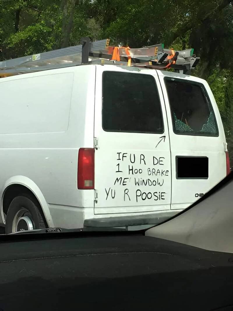 White van with a humorous sign on the side reading 'IF U R DE 1 H00 BRAKE ME' WINDOW YU R POOSIE.
