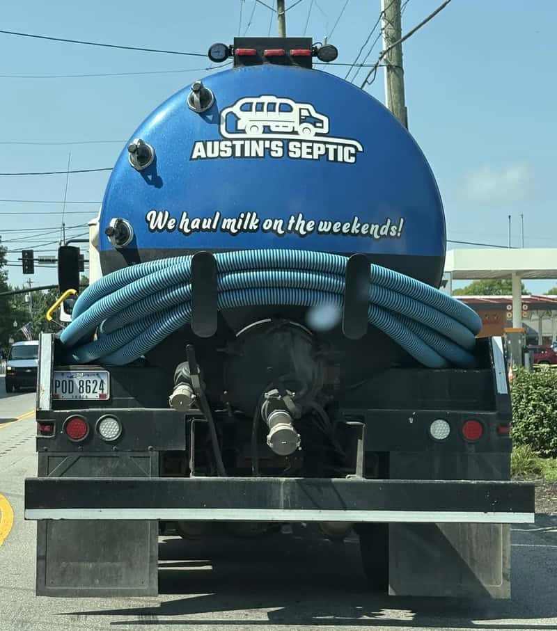 A septic truck with a blue tank labeled 'AUSTIN'S SEPTIC' and 'We haul milk on the weekends!'.