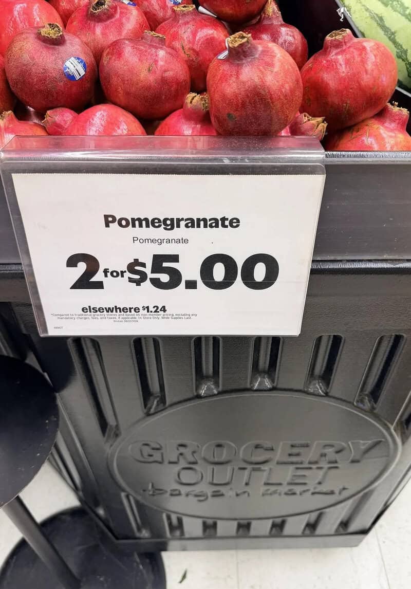 Pomegranates on display with a sign for 2 for $5.00.