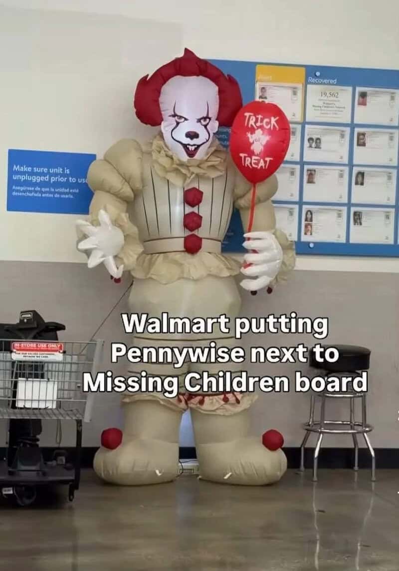 Inflatable Pennywise clown holding a 'Trick or Treat' balloon at Walmart.