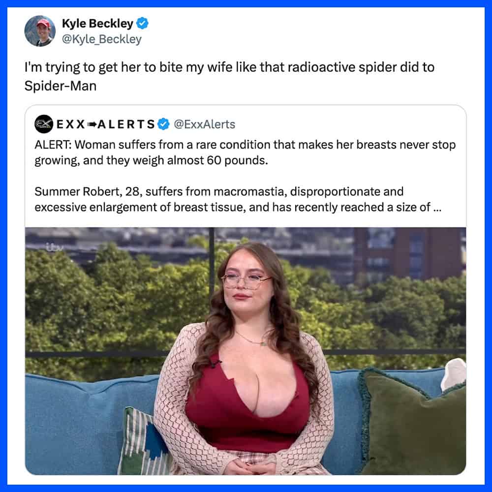 Woman with large breasts sitting on a couch outdoors, wearing a red top and glasses.