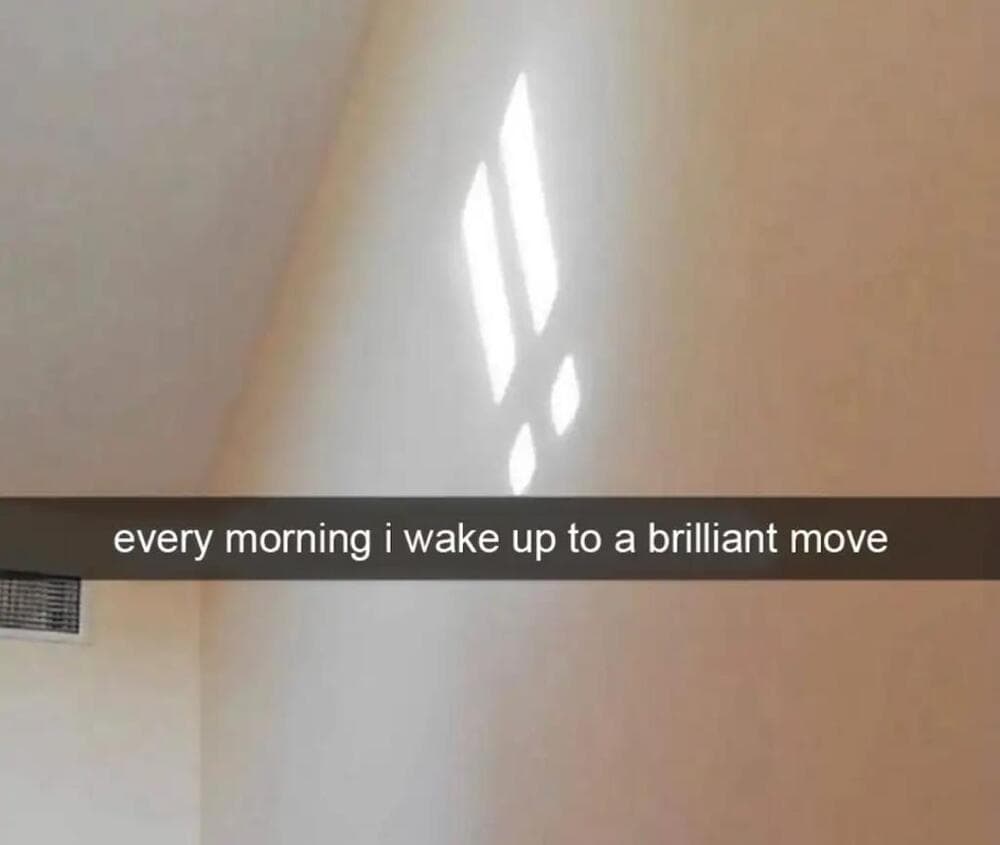Sunlight creates a pattern of four rectangles and a circle on the wall.