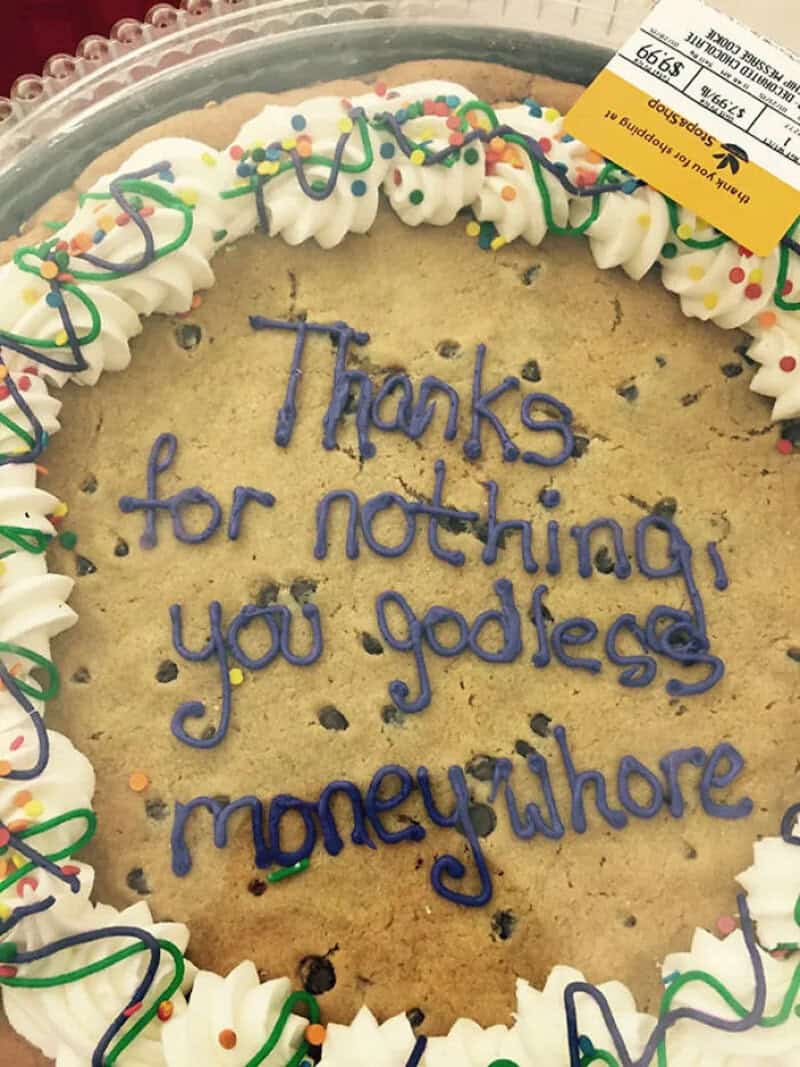 Cake with colorful sprinkles and a message saying thanks for nothing you godless money whore.