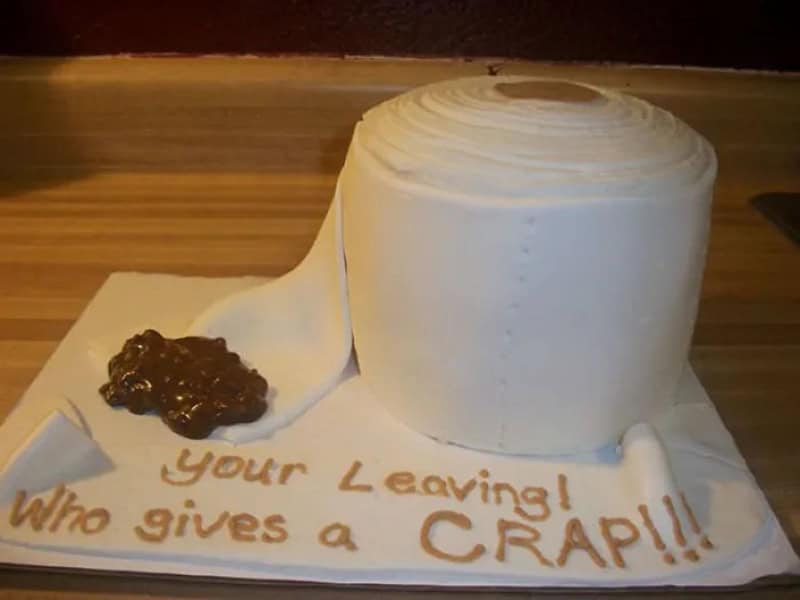 Cake with a white icing and a message about leaving and giving a crap.