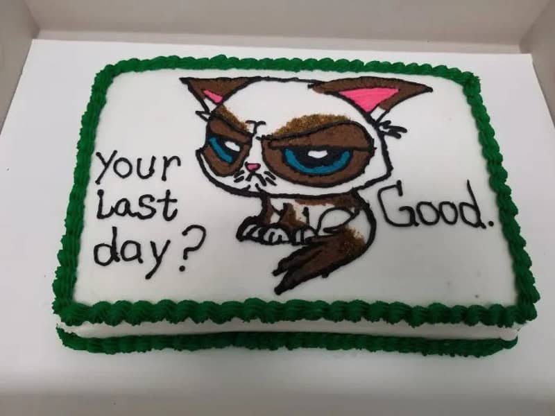 Cake with a grumpy cat and the text 'Your last day? Good.'.