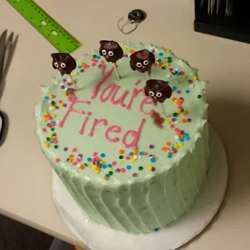 Cake with four poop emoji toppers and 'You're Fired' written on it.