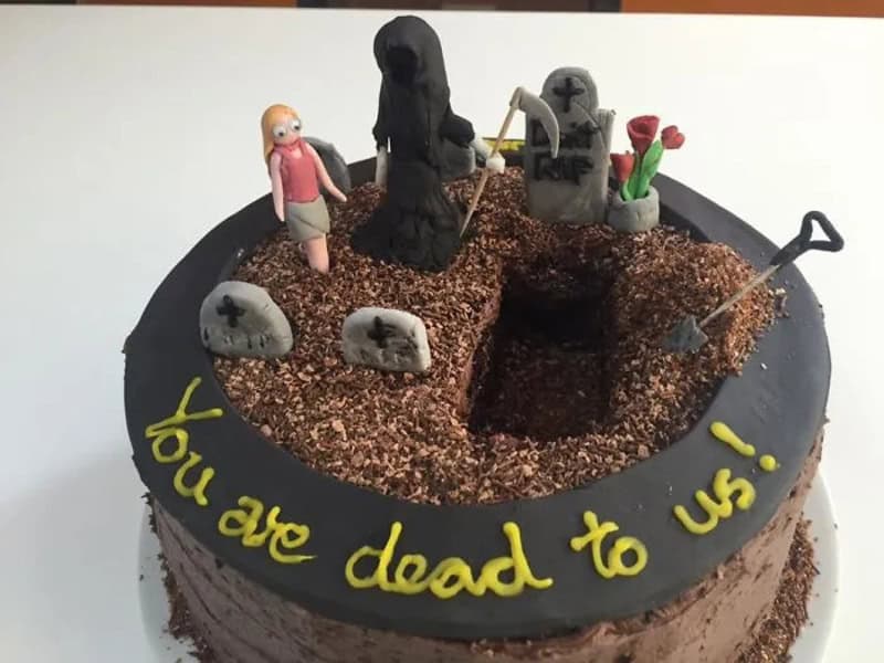 Cake with a graveyard scene and a 'you're dead to me' message.