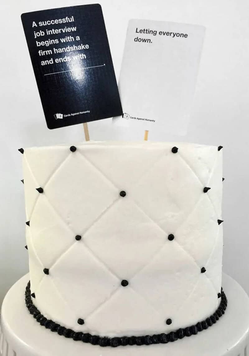 Cake with two signs: 'A successful job interview begins with a firm handshake and ends with' and 'Le.
