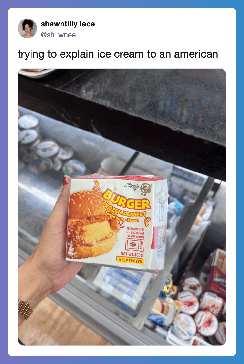 Person holding a burger-shaped ice cream box in front of a freezer with ice cream.
