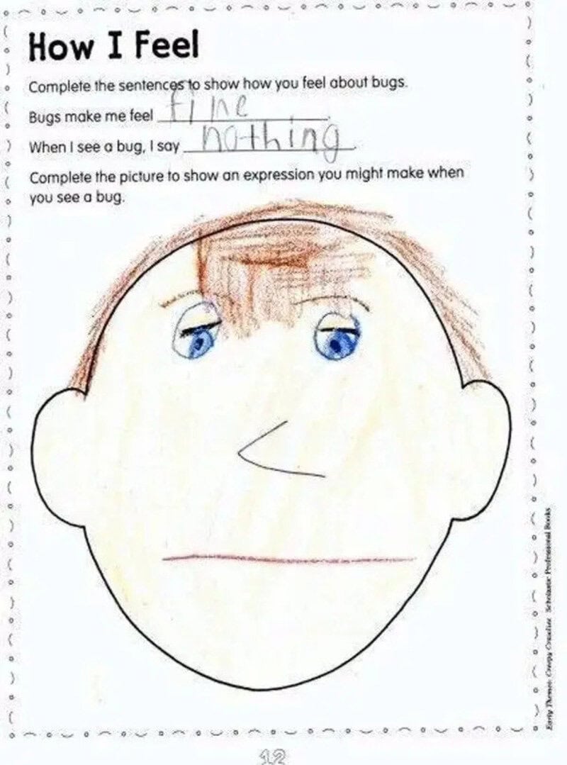 Child's drawing of a face with blue eyes, brown hair, and a simple smile.