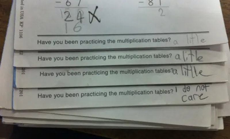 Stack of math homework with funny kid answers about multiplication practice.