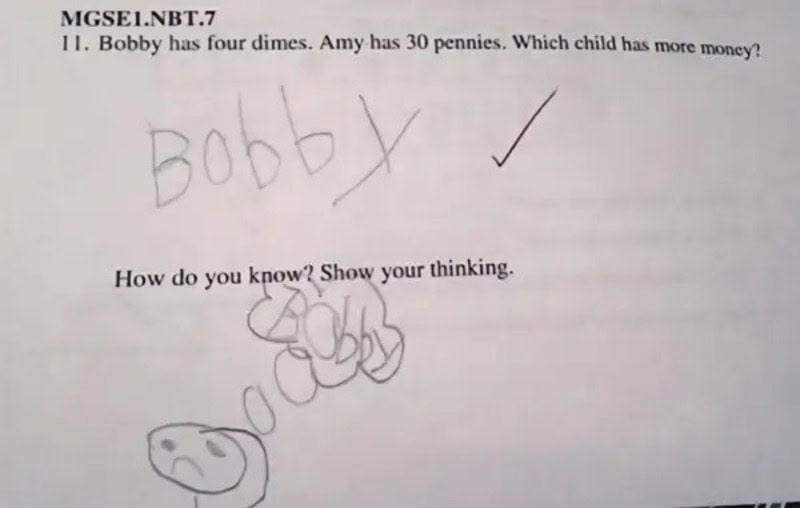 Child's handwriting and drawing on a worksheet about money.