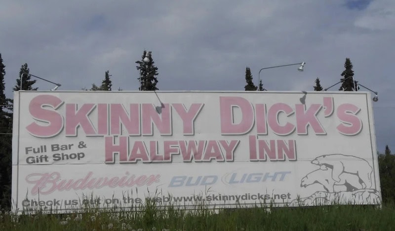 Billboard for Skinny Dick's Halfway Inn with beer brands and a pig illustration.