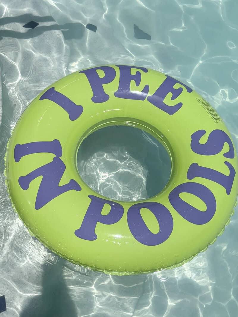 I PEE NO POOPS on a green pool float in the water.