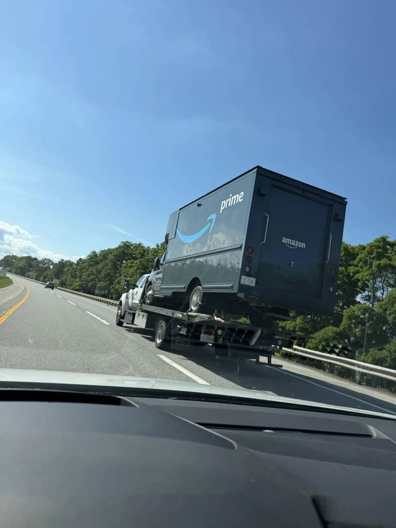 Amazon Prime delivery truck on a highway, seen from inside a car.
