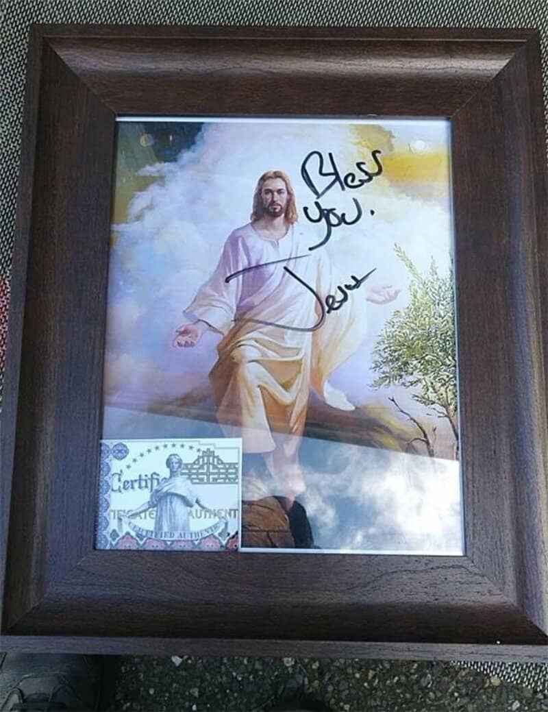 Framed picture of Jesus with a signature and message.