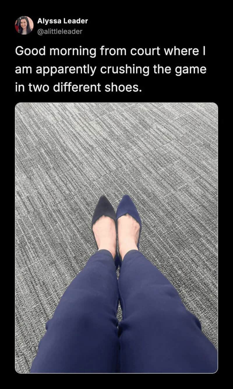 Person in blue shoes and pants standing on gray carpet, two different shoes.